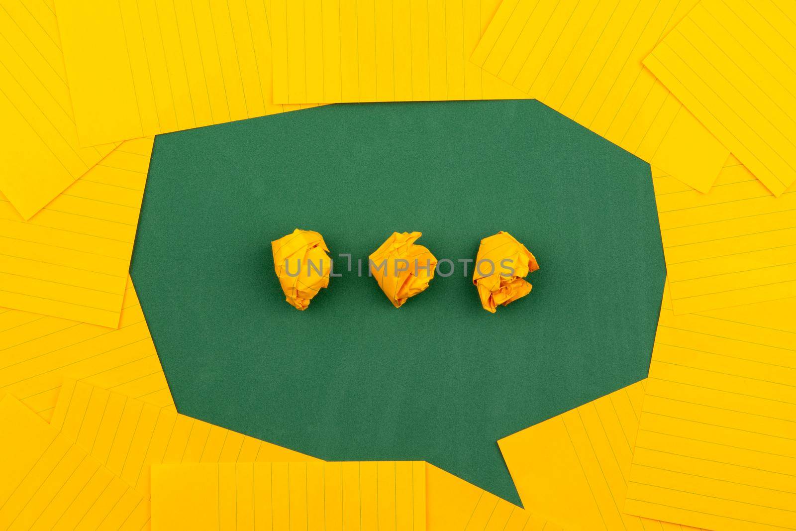 orange sheets of paper lie on a green school board and form a chat bubble with three crumpled papers by lunarts