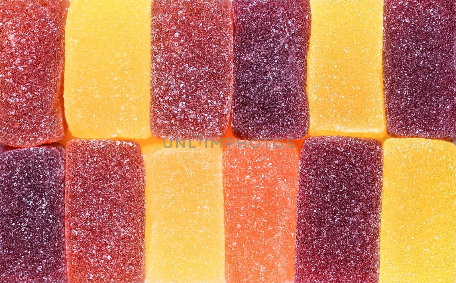Marmalade sweets background. Gelly candies close up. Colorful swets. Jelly cubes sprinkled with sugar