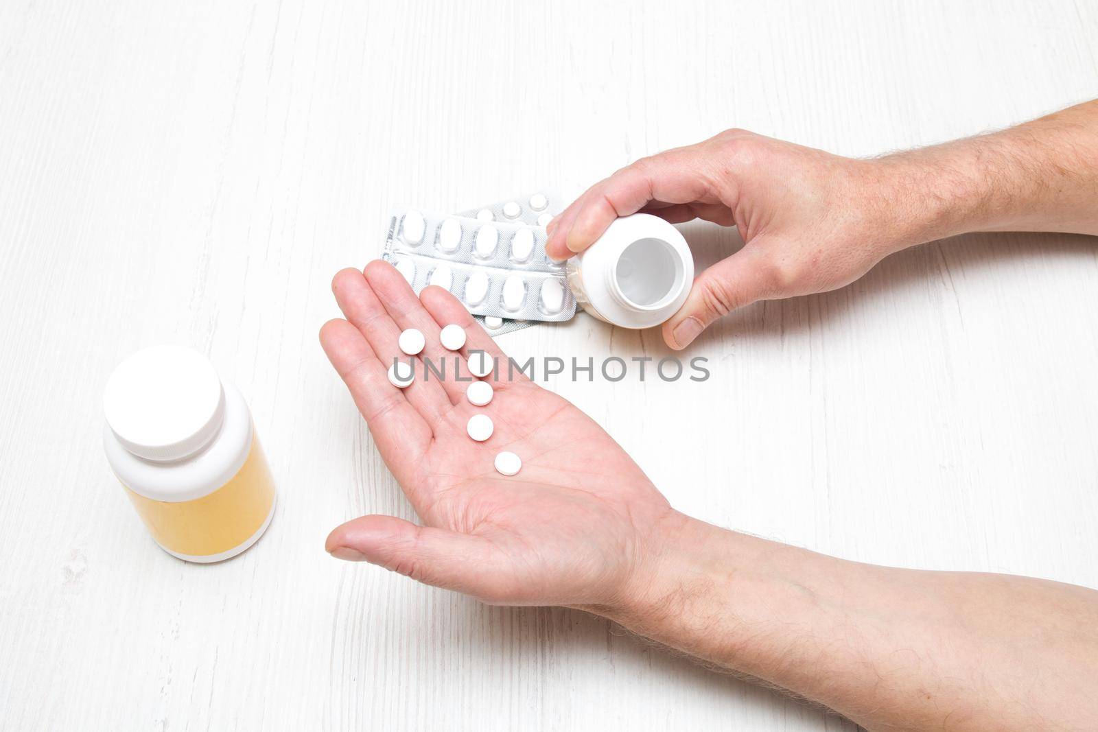 male hand holds a jar of medicine on a laptop background, online instinct, chat tips by natashko