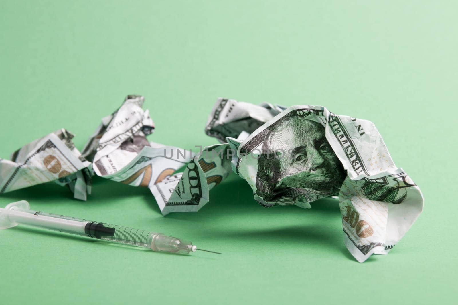 crumpled stallar bills and insulin syringe