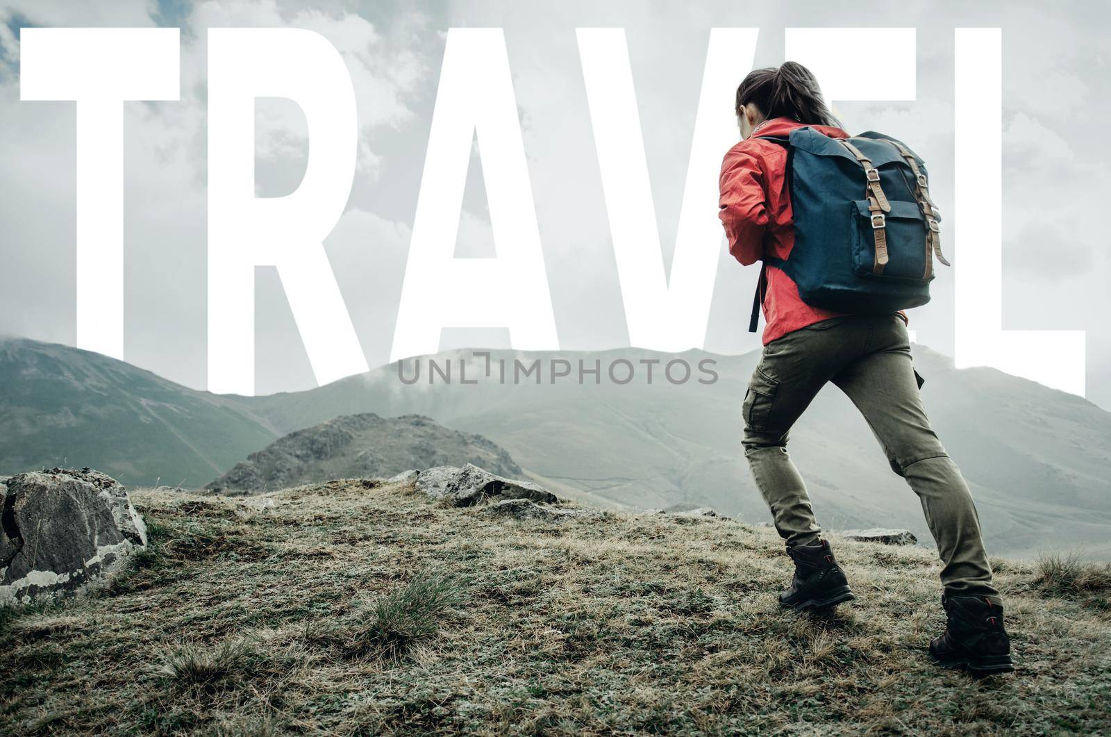 Hiker young woman with backpack going up to word travel over mountain ridge outdoor.