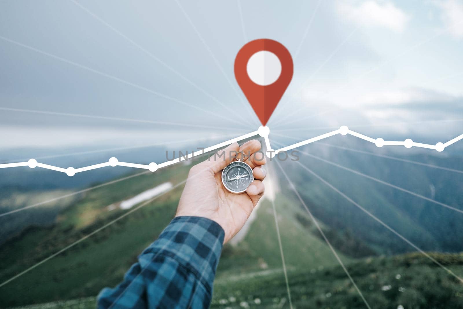 Male hand with compass and GPS route in mountains, pov. by alexAleksei