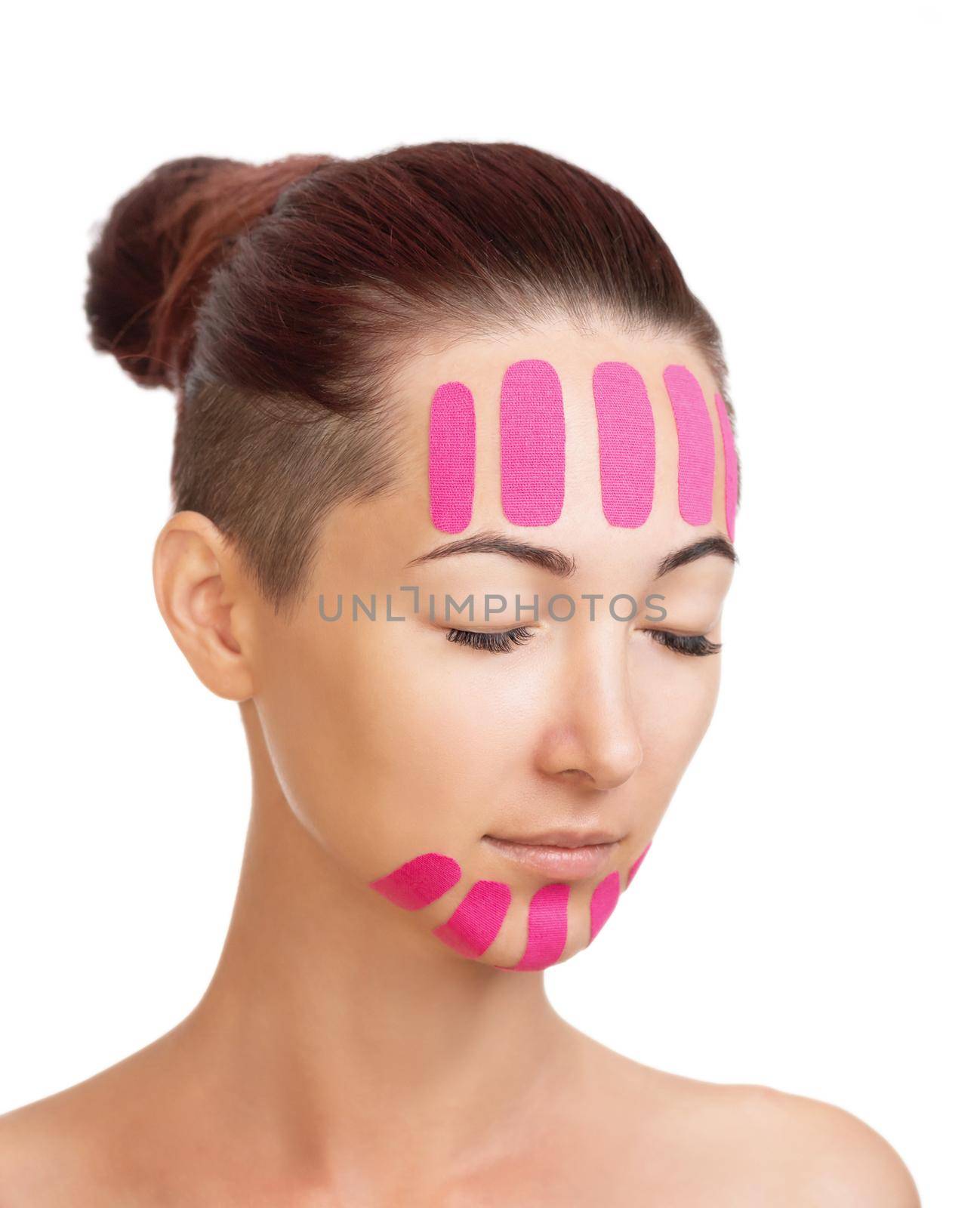 Woman with kinesio tapes on forehead and chin for facelift. by alexAleksei