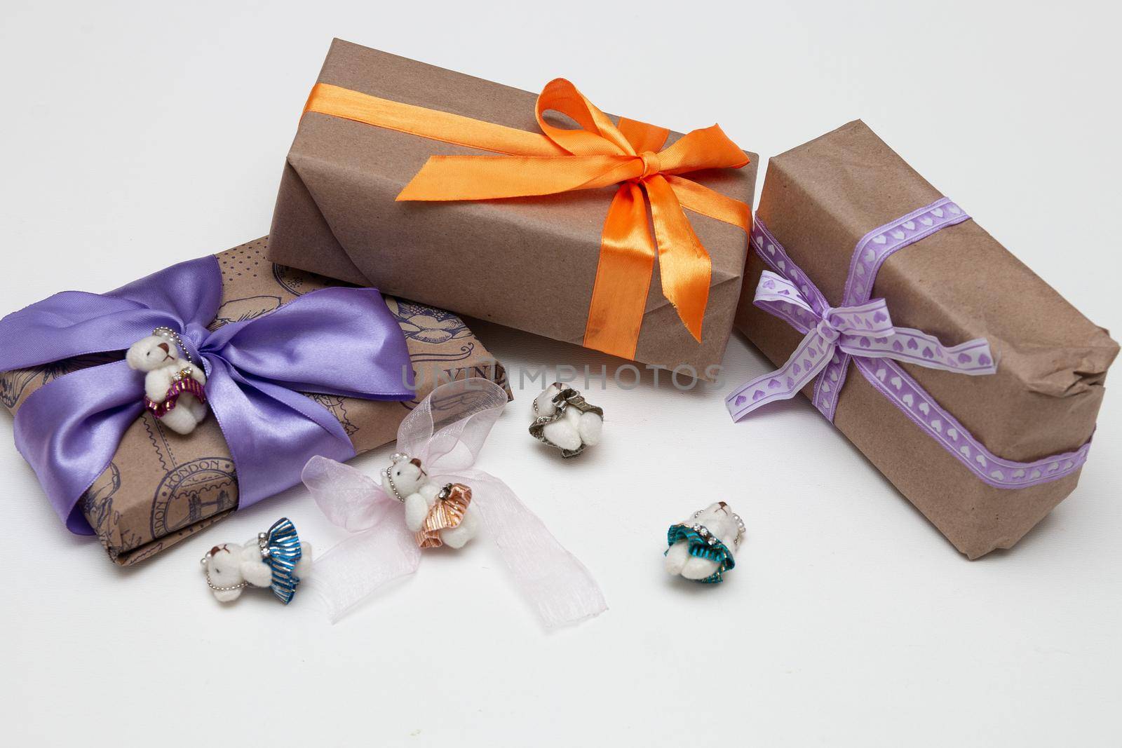 gifts in boxes on a white background place copy top view golden ribbon with bow wrapped in brown paper purple ribbon braid cute bears for decoration