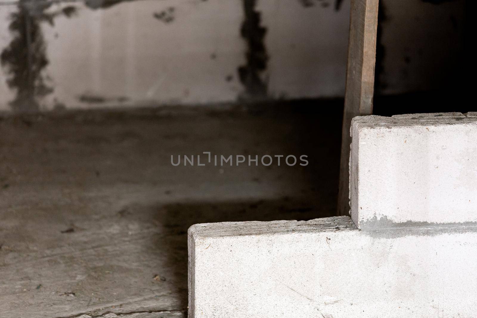 interior of a country house under construction. Site on which the walls are built of gas concrete blocks and wheelbarrow