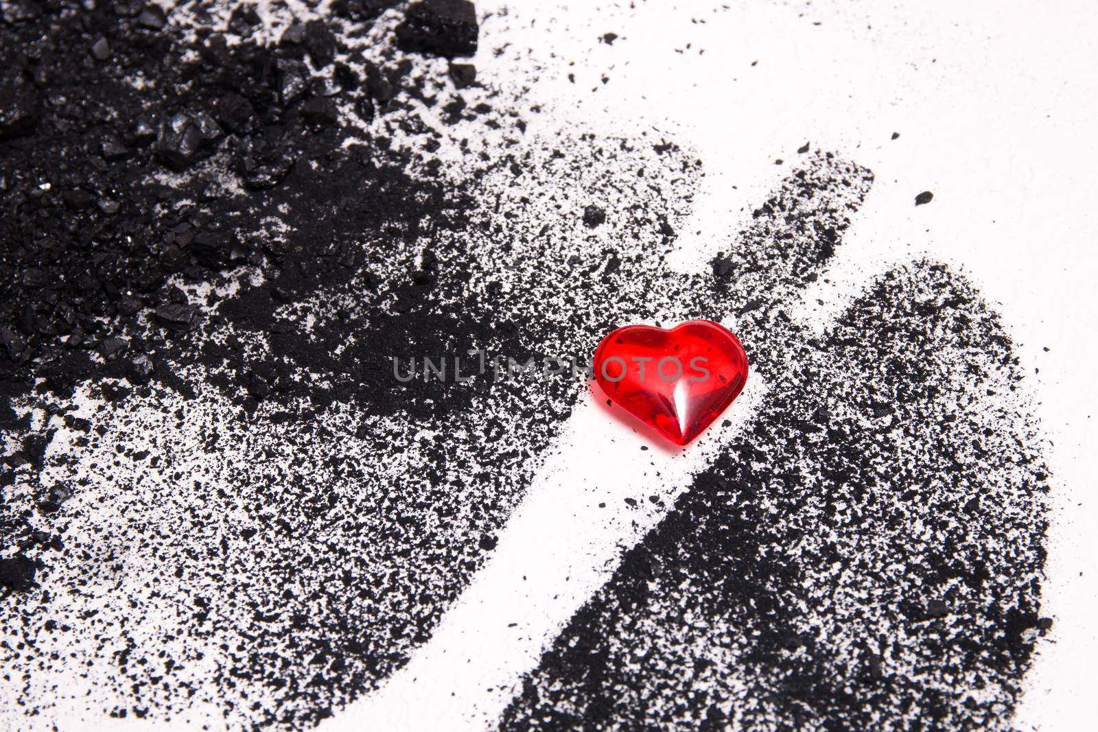 silhouette of human lungs from coal dust on a white background, lungs from pieces of coal and a small red glass heart, health care concept, respiratory diseases, copy space