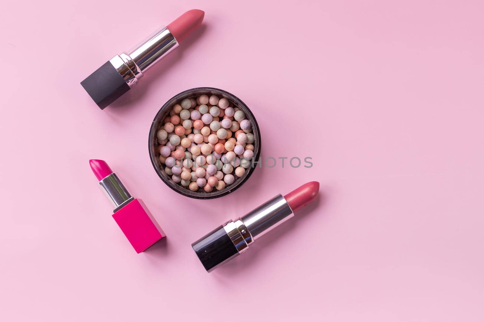 Decorative cosmetics and accessories for makeup on grey background