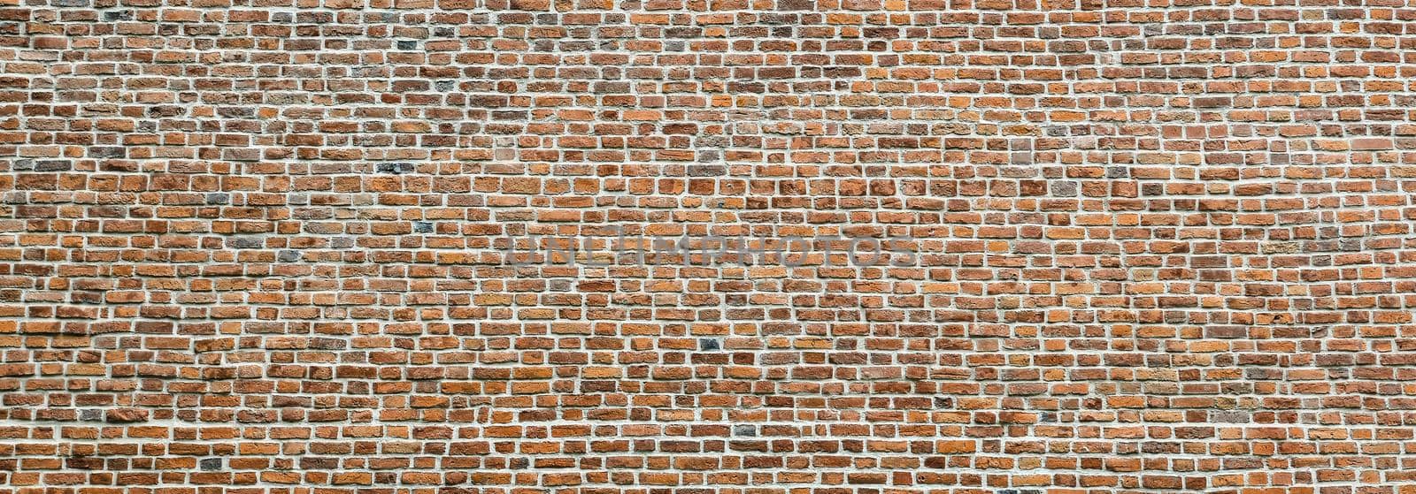 Brick wall, wide panorama of masonry. Wall with small Bricks. Modern wallpaper design for web or graphic art projects. Abstract template or mock up.