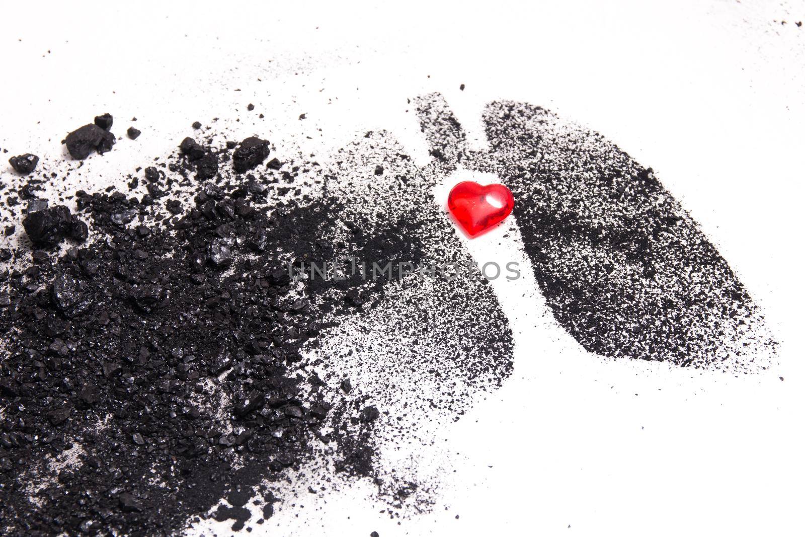 silhouette of human lungs from coal dust on a white background, lungs from pieces of coal and a small red glass heart, health care concept, respiratory diseases, copy space by natashko