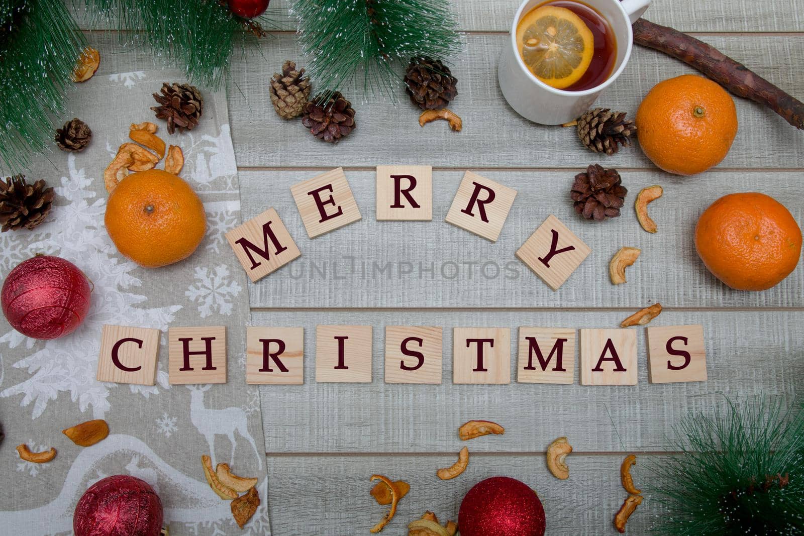 pine branches, Christmas toys, tangerines, tea with lemon, Christmas mood, top view, wooden background by natashko