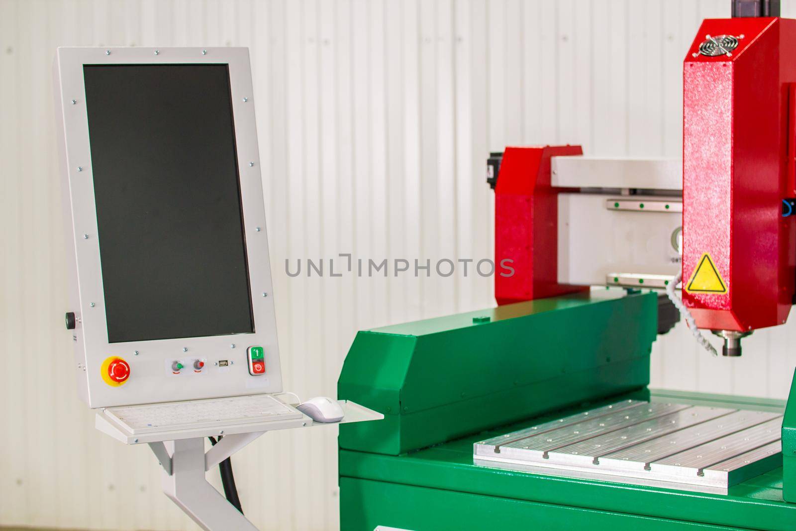 Screen and automated CNC equipment for working with metal. The programmed robot head. Telephoto shot