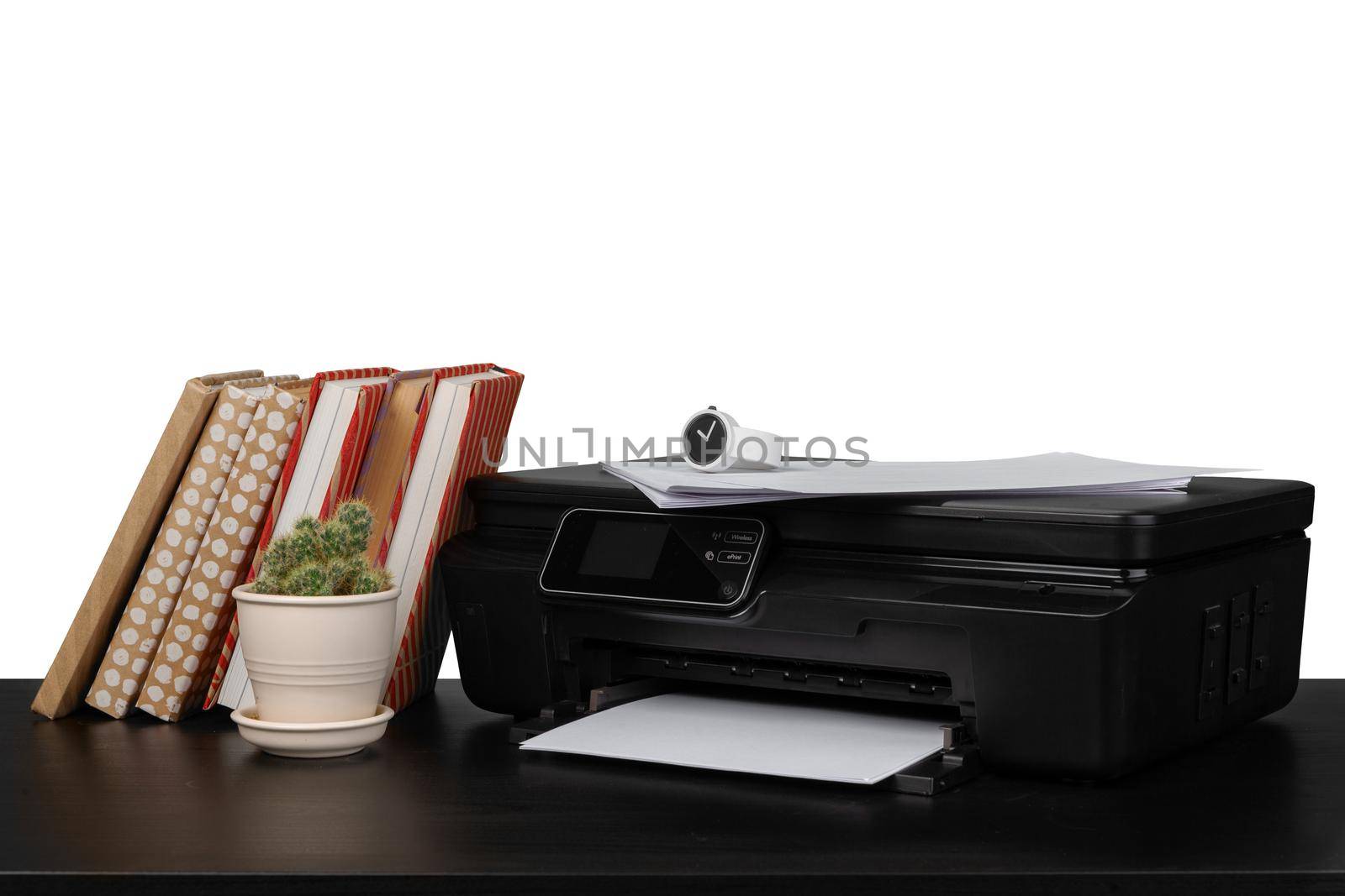 Working table with printer and stacked books on white abckground, close up