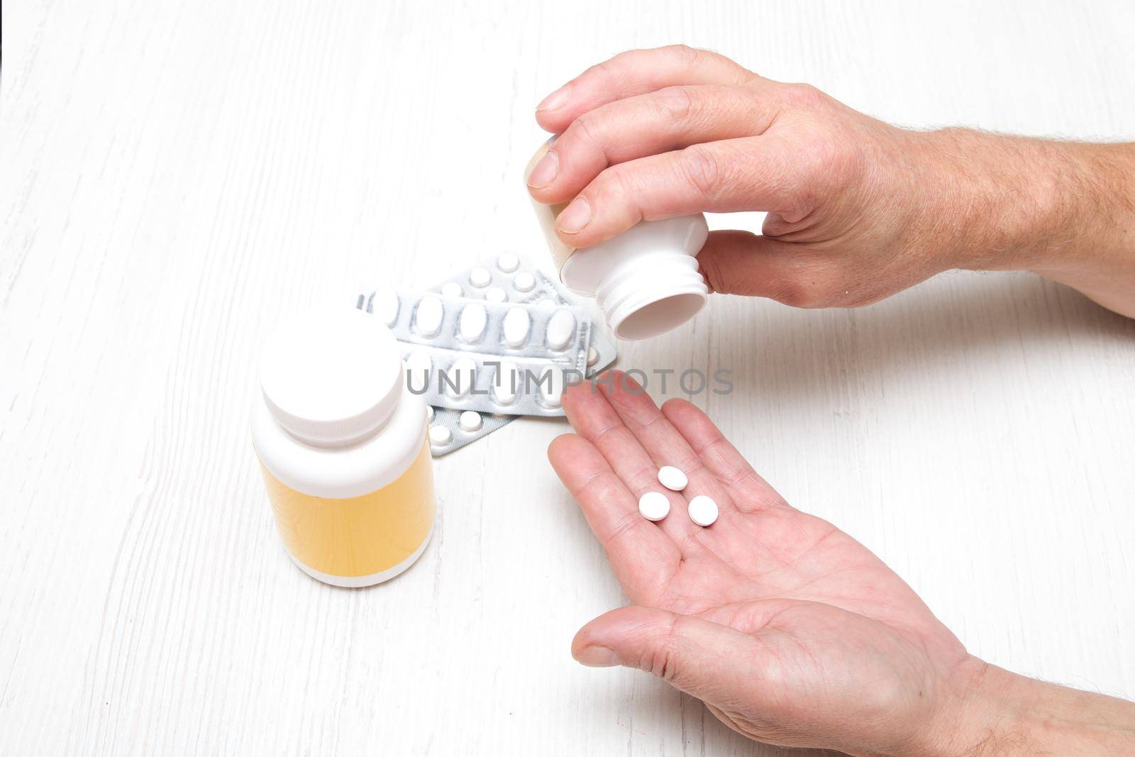 male hand pills tablets in the palm