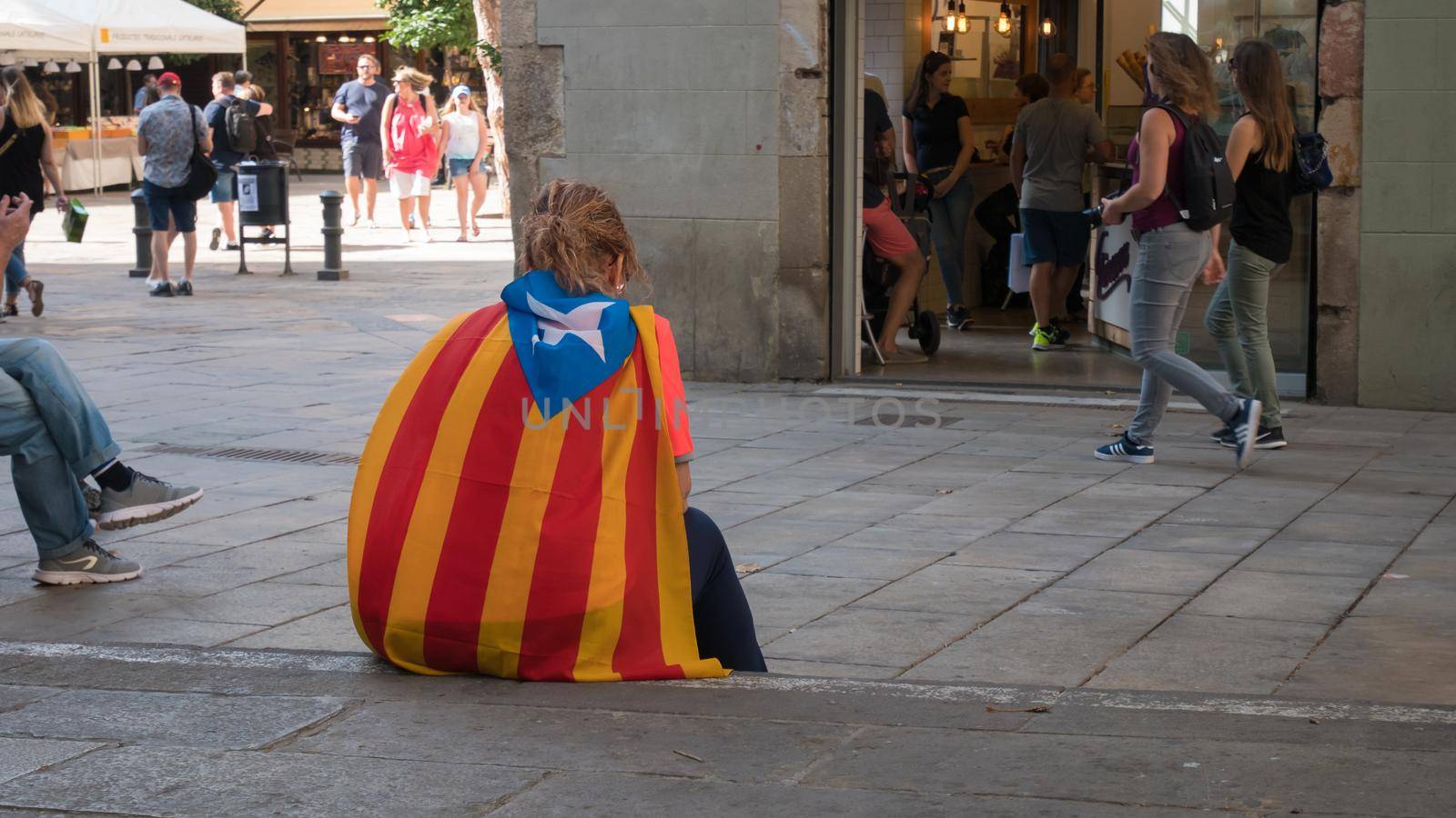 BARCELONA, SPAIN - SEPTEMBER , person sitting on the ground for independence for Catalonia in Barcelona, Spain, telephoto shot