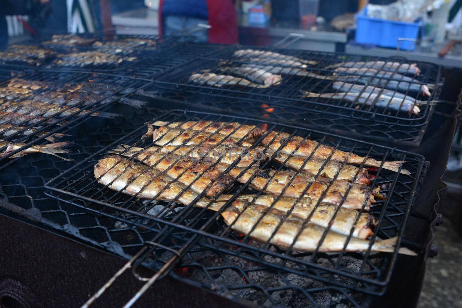 fried herring on the grill on the street market