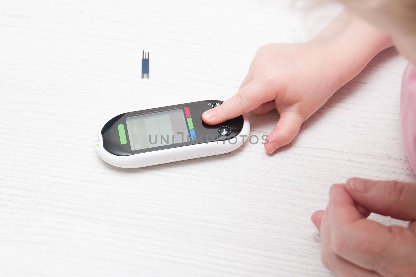 small child presses the button glucose meter, blood glucose meter, childhood diabetes, child health care