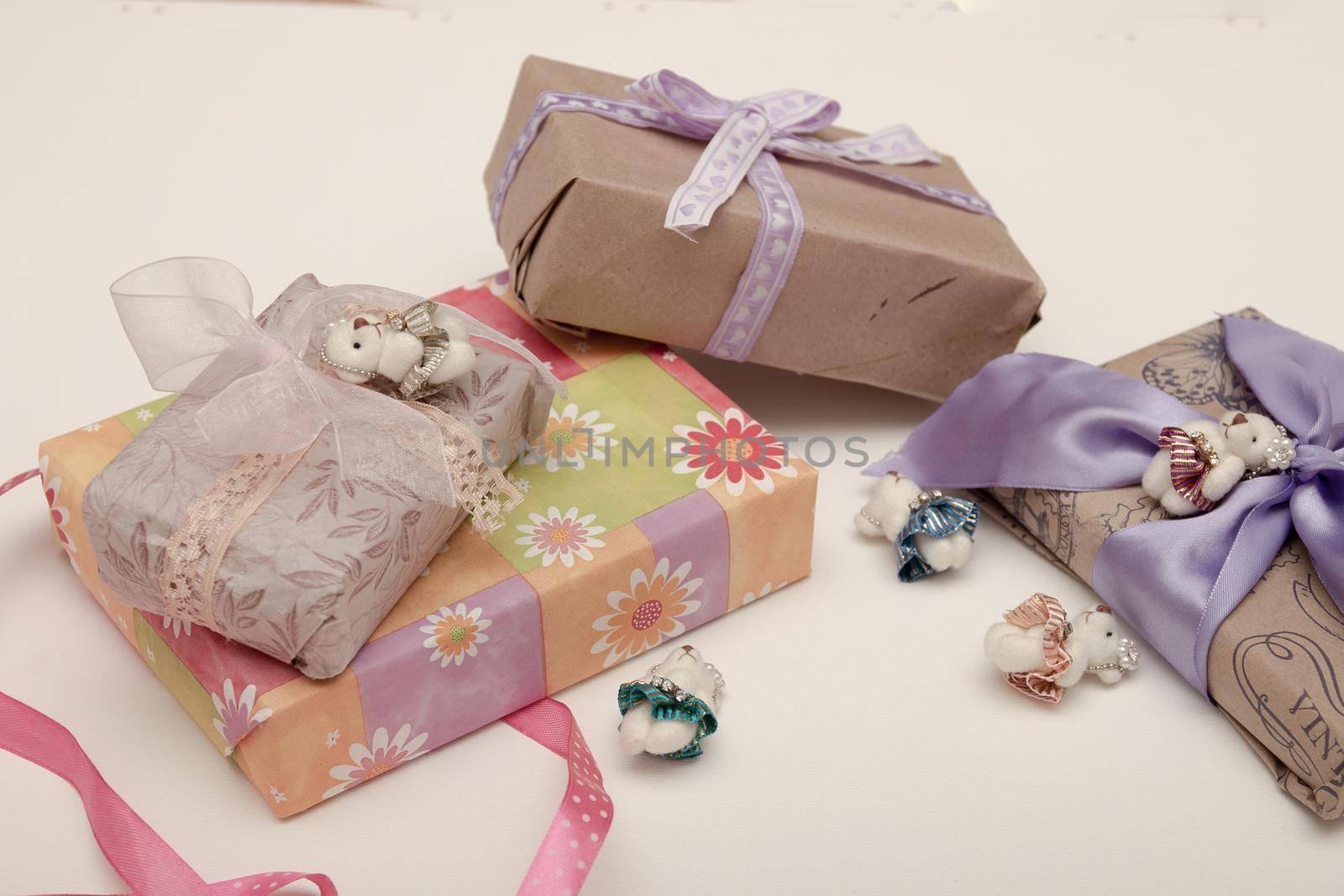 gifts in boxes on a white background place copy top view golden ribbon with bow wrapped in brown paper purple ribbon braid cute bears for decoration bright colorful by natashko