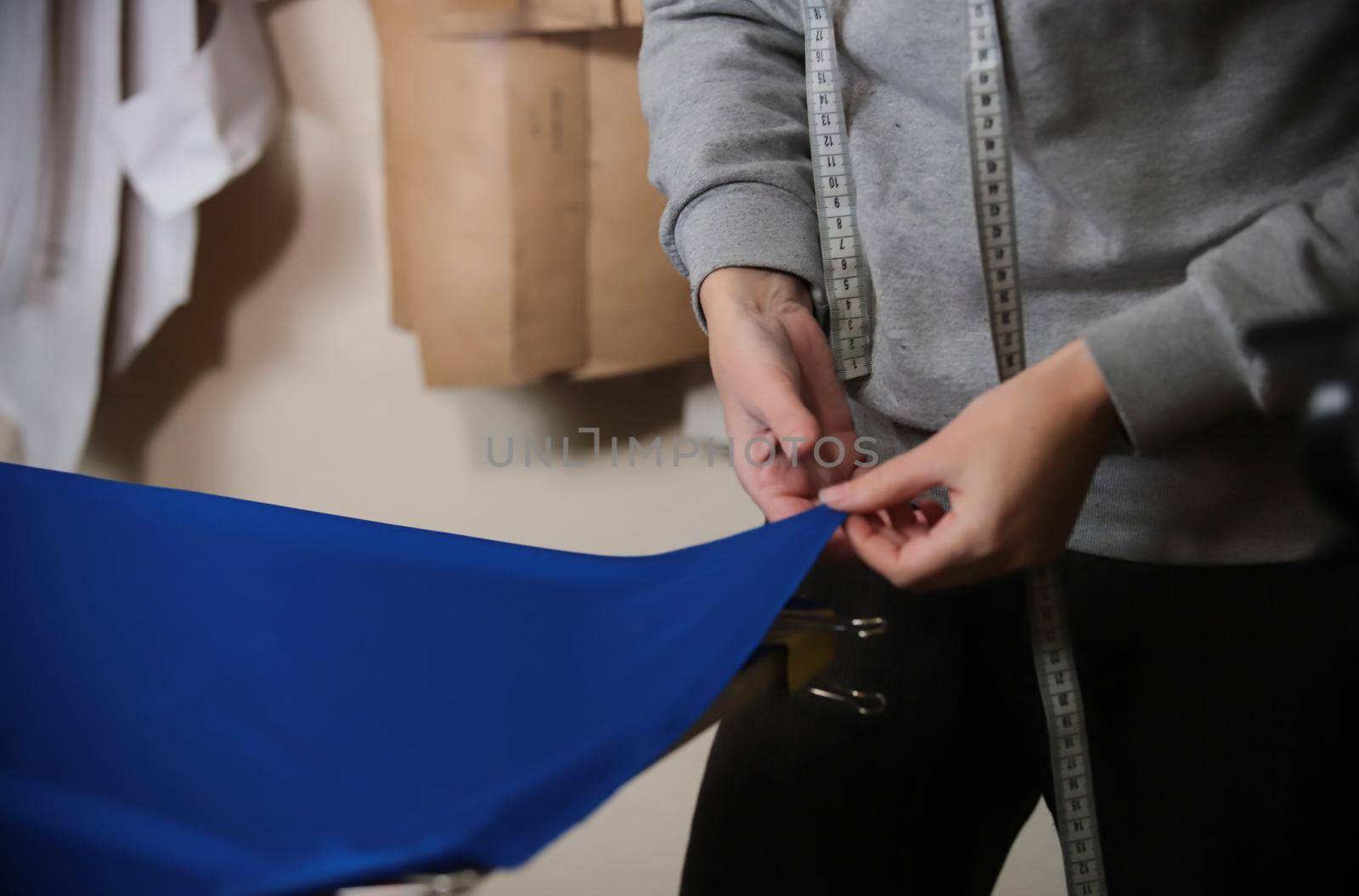 Worker with meter at the factory holding a cloth