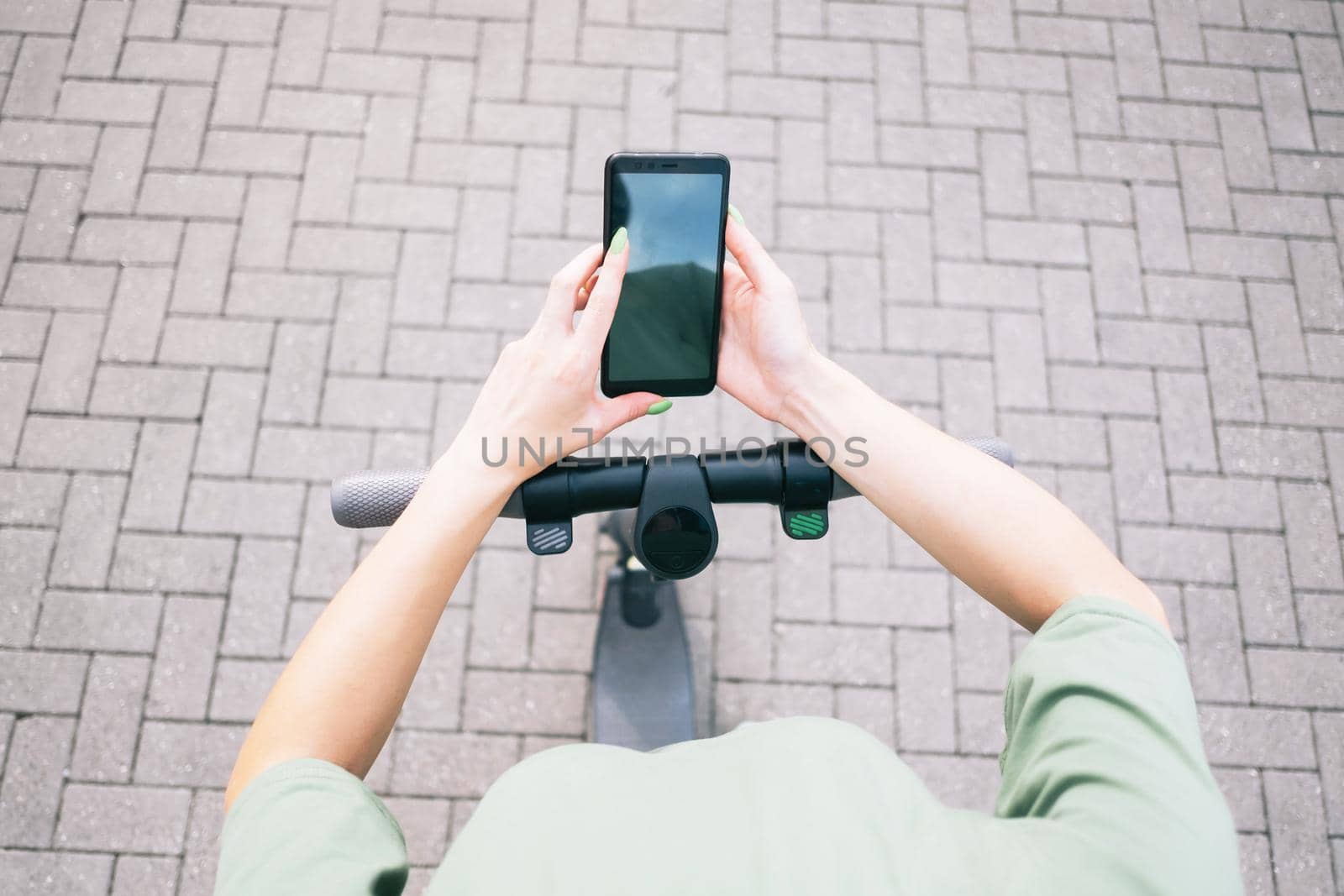 Woman using smartphone while standing with an electric scooter, mock-up. Point of view in first person.