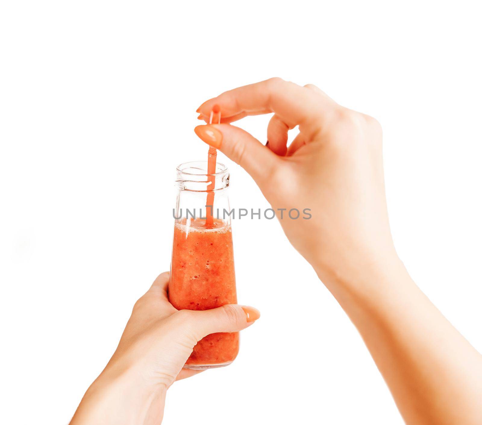 Young woman holding bottle of healthy berry smoothie with tube. Point of view in first person.