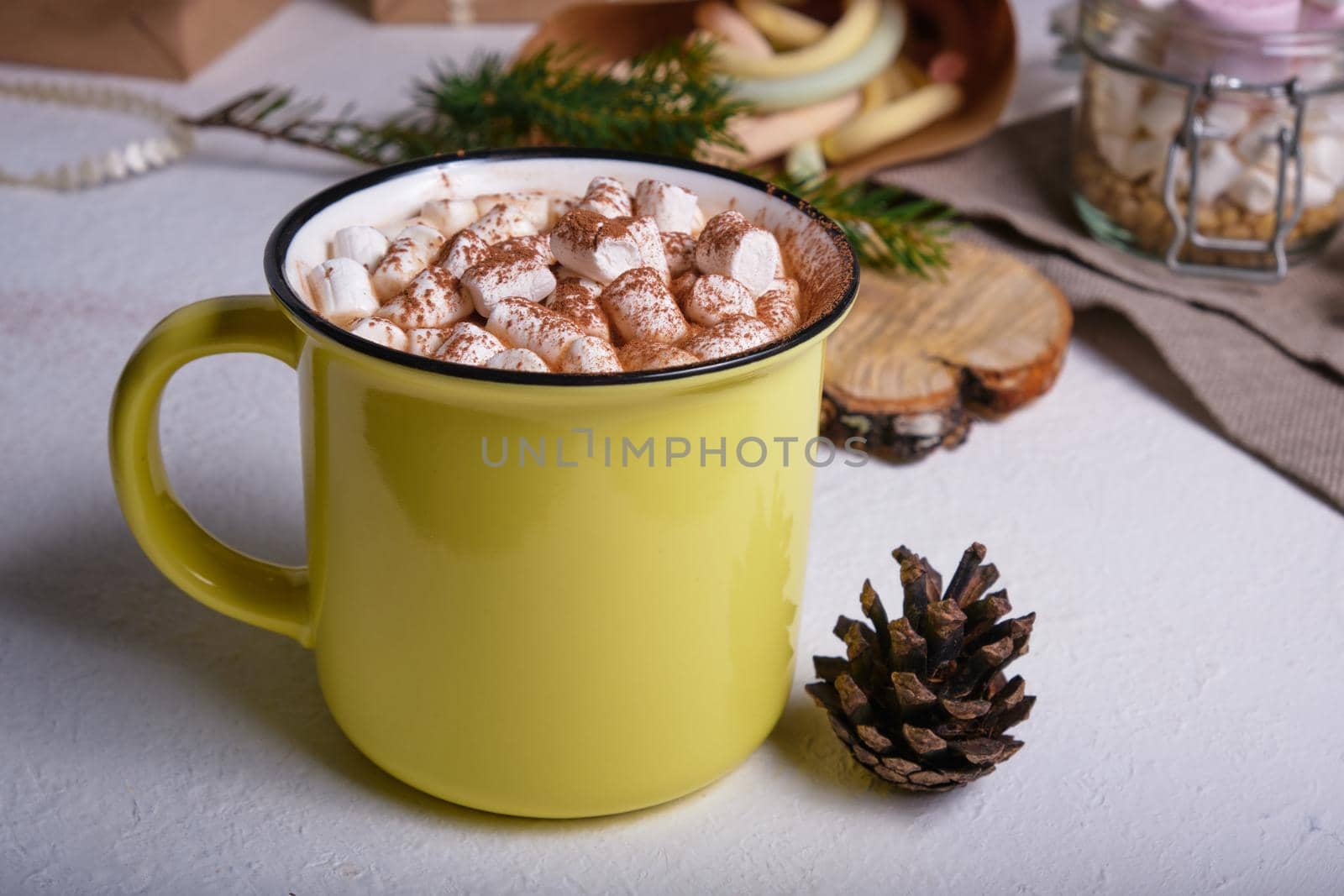 yellow cup with cocao decorated with marshmallows close-up, marshmallows on the background by natashko