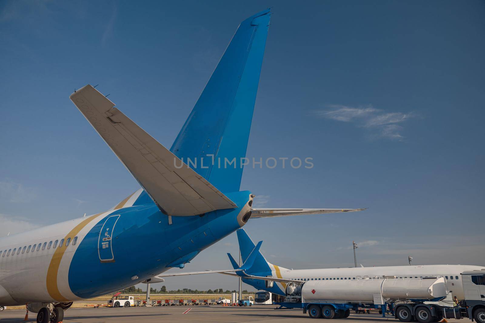 Two modern big airplanes in airport with blue sky in the background. Plane, transportation concept