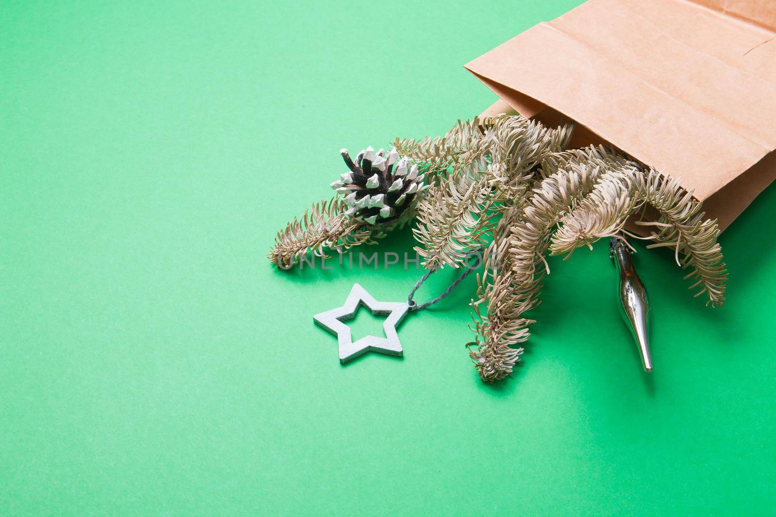 bouquet decorated with pine cones and Christmas toys, green background copy space