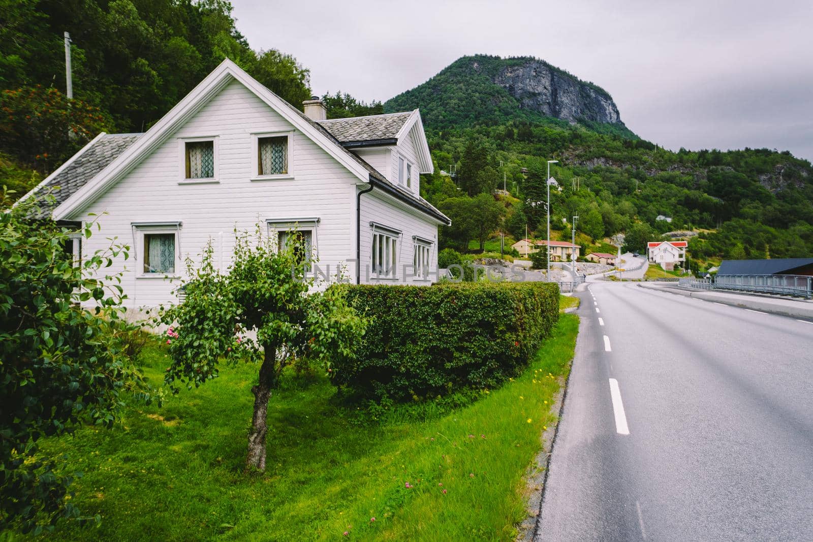 Cityscape with white spaced-out traditional house in norway. Norway house, traditional Scandinavian country hut in village. White Wooden House In Norway. Old wooden architecture in Norway. White home by Tomashevska
