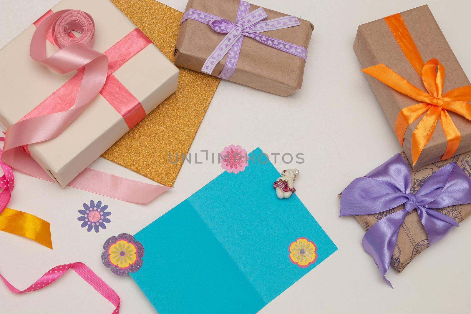 gifts boxes with bright ribbons and bows on a white background blue postcard, money, dollar bills, euros, copy place, top view, birthday, Thanksgiving, holiday, new year, christmas, flat lay by natashko