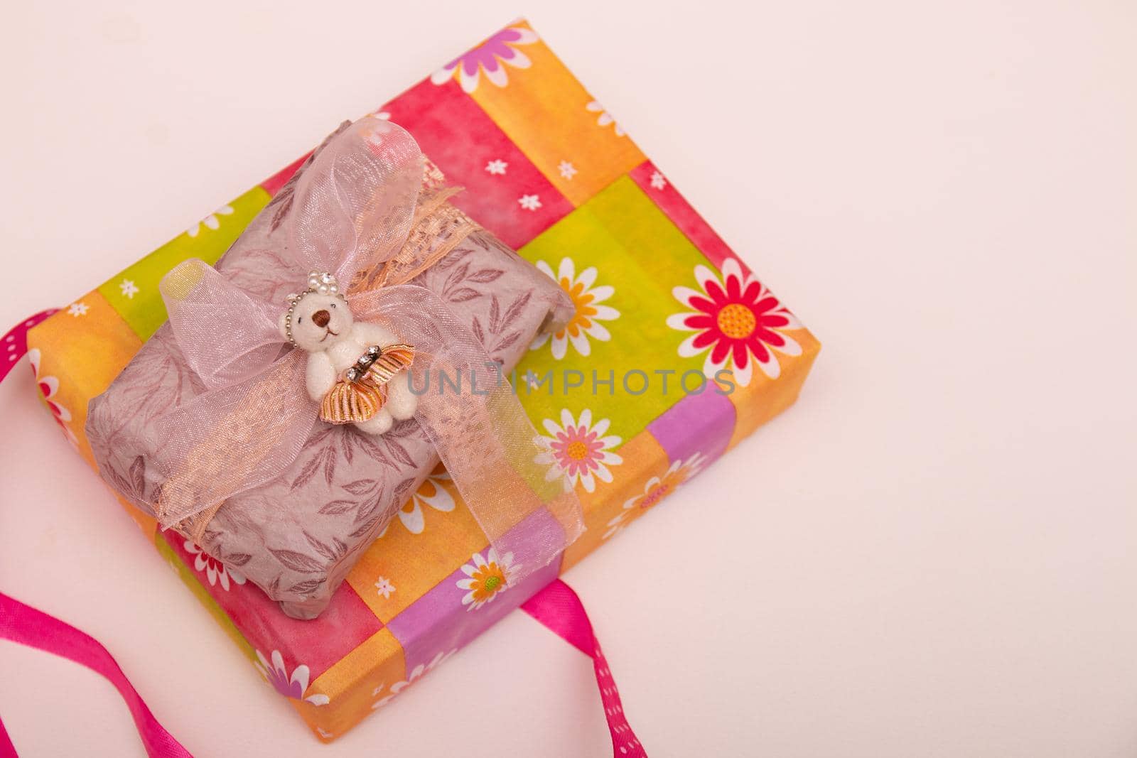 present on a white background with lilac ribbon bow brown paper