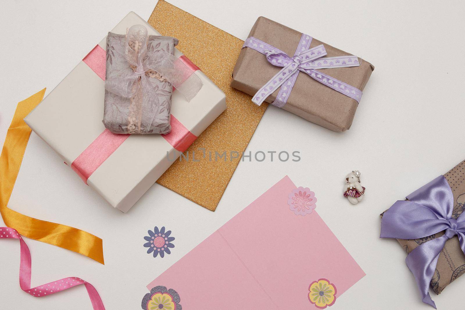 pink card paper and beautiful gifts on a white background Thanksgiving, birthday, mother's day, copy space,paper flowers,ribbon and bows decor