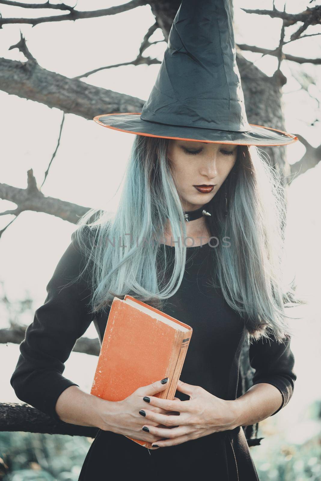 Young witch with book by alexAleksei