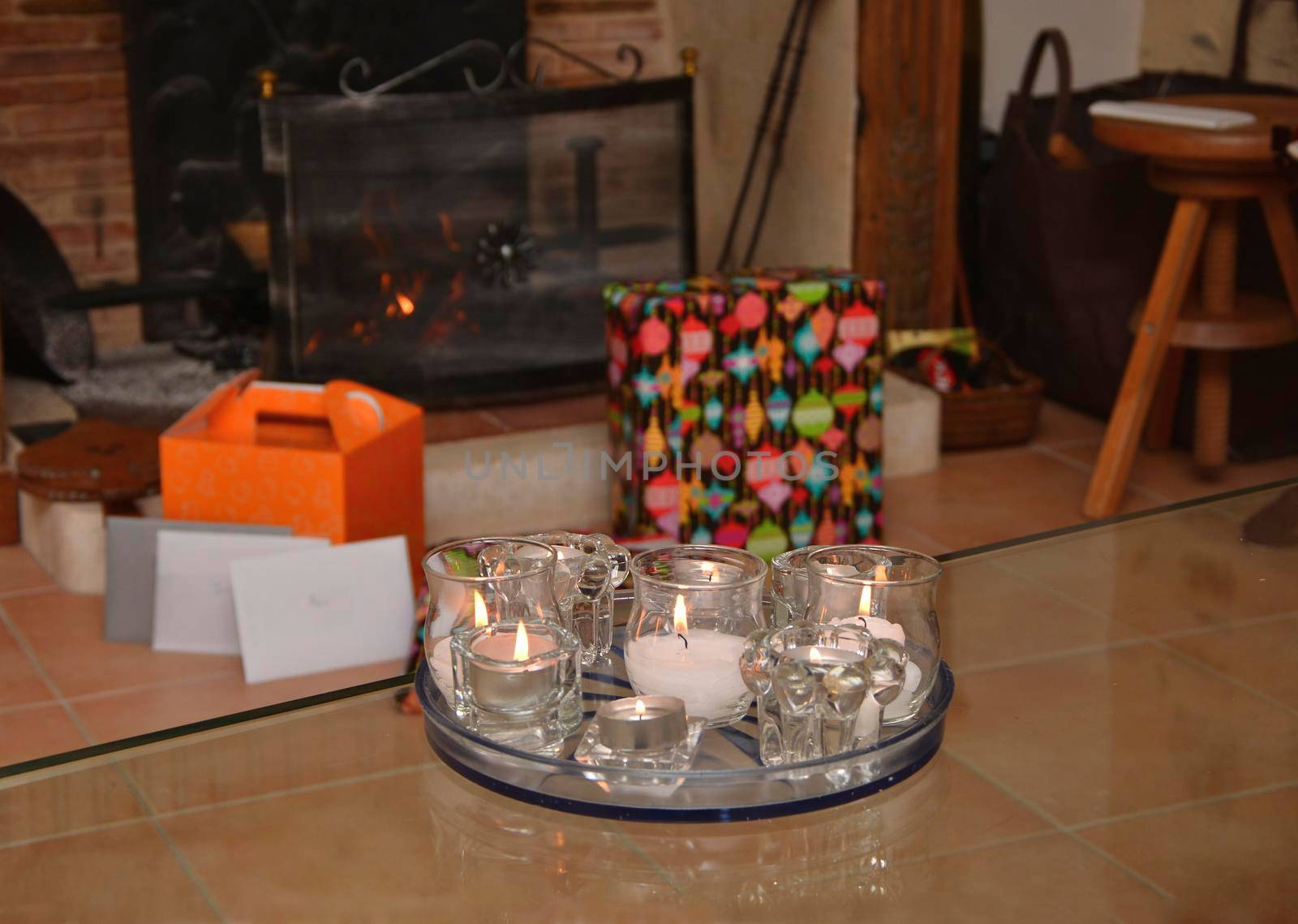 Christmas candles in front of the fireplace.