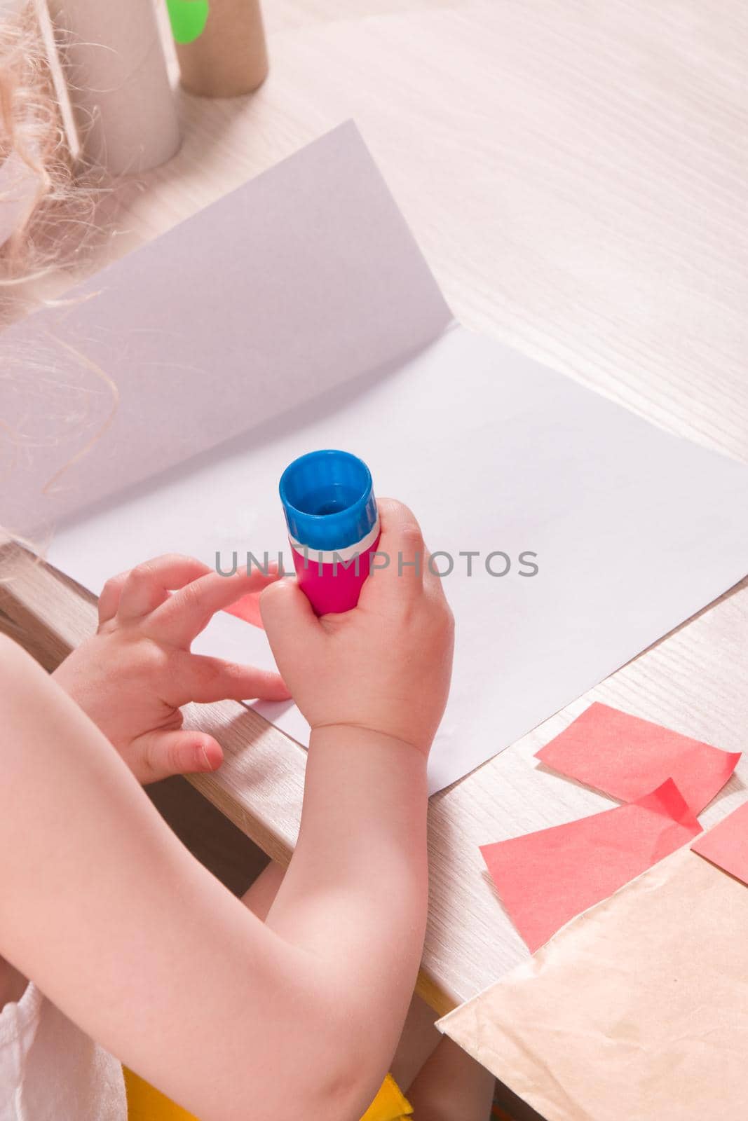 the child makes an applique, crafts from colored paper and toilet paper stools, what to do with the child at home, development of imagination and fine motor skills of hands