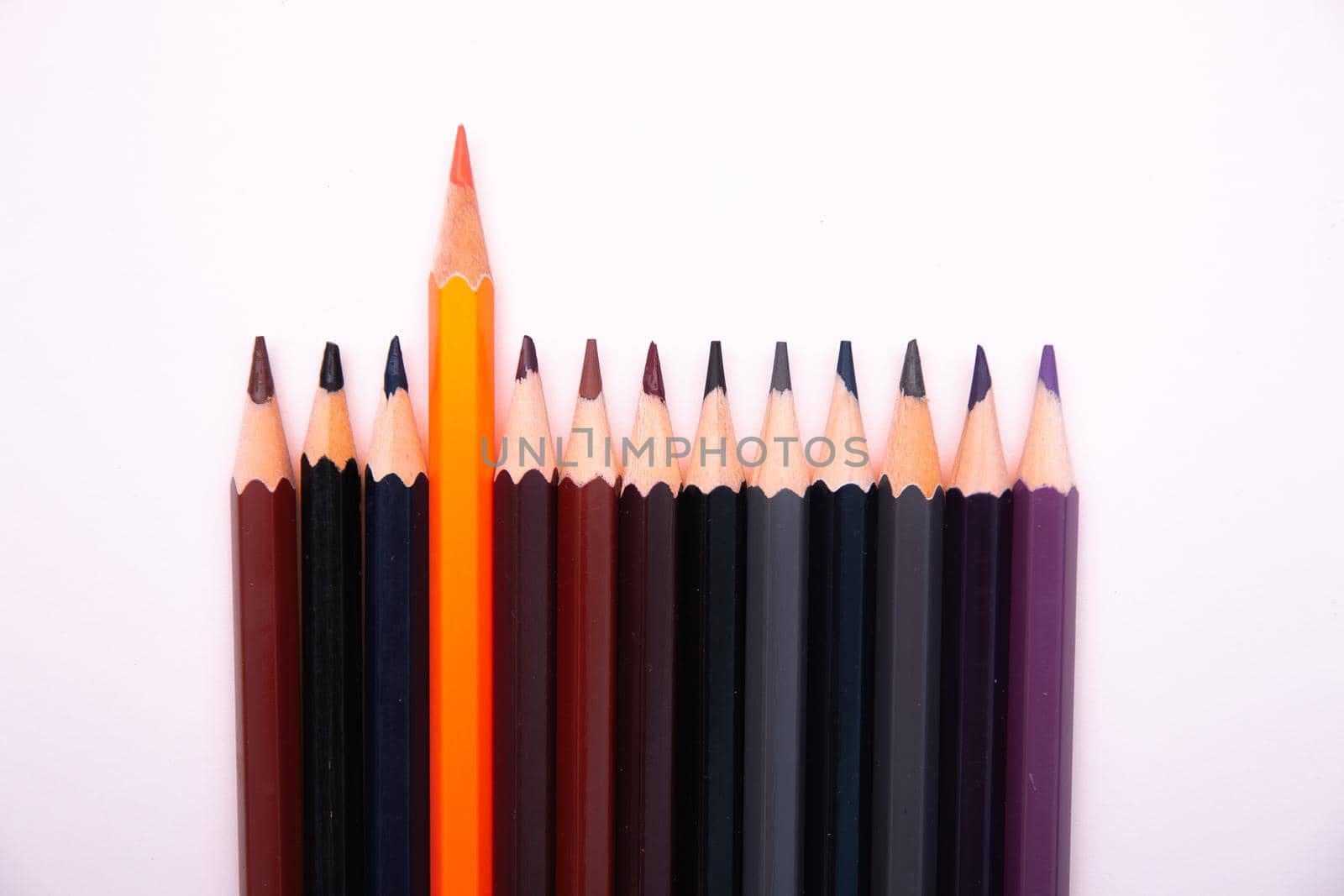 color pencils on a white background isolated texture top view copy space brown black grey blue violet uniqueness abstract
