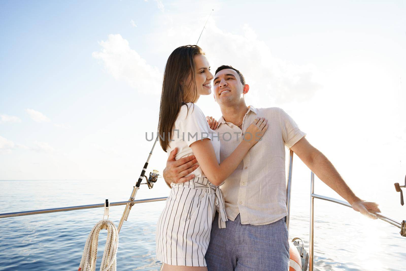 Happy couple in love on a yacht in summer on romantic vacation