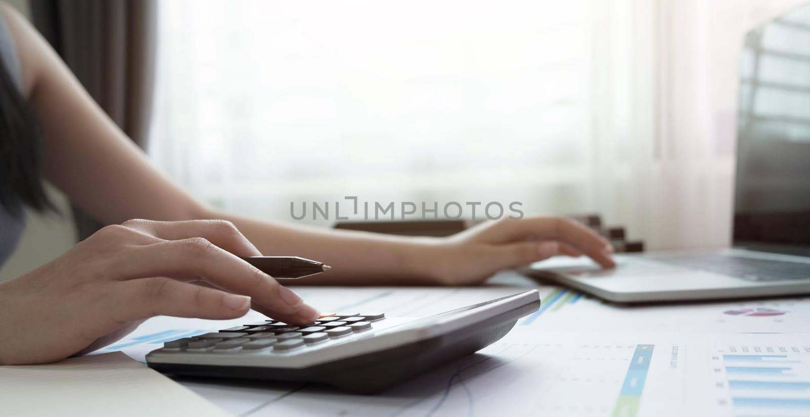 woman using calculator for calaulating finance, tax, accounting, statistics and analytic reserch concept.