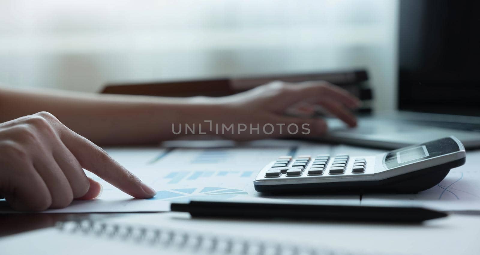 Close up Business or accountant using calculator calaulating finance, tax, accounting, statistics and analytic research concept.