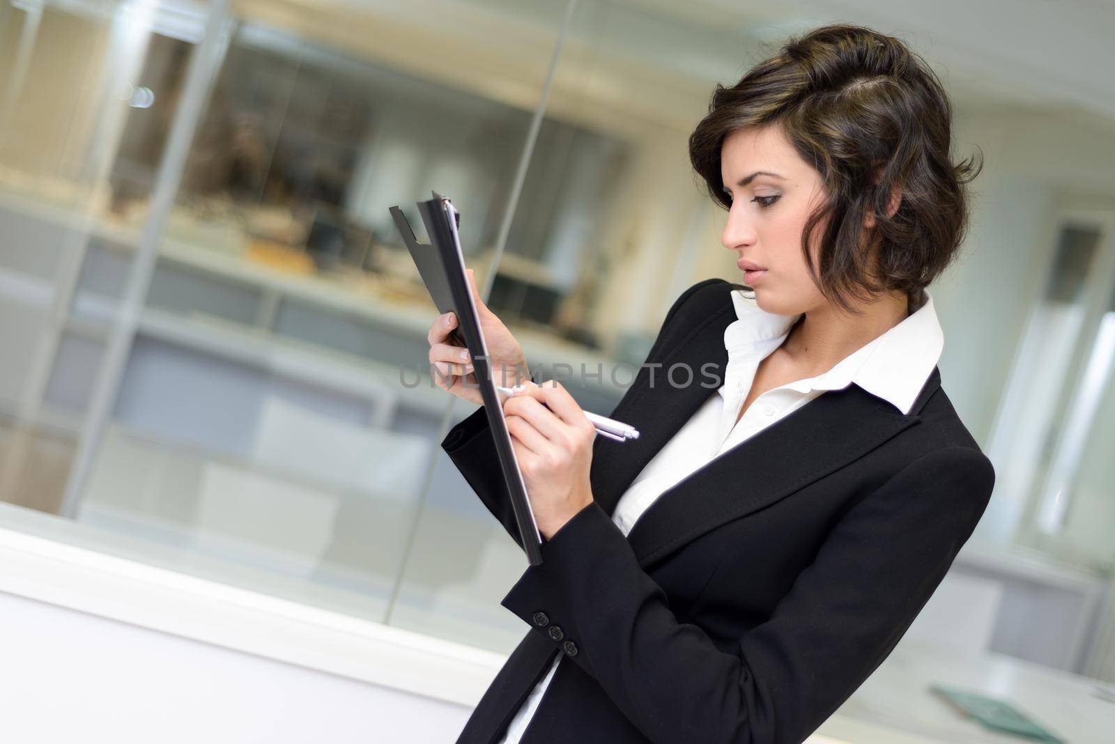 Business woman in an office. Crossed arms by javiindy