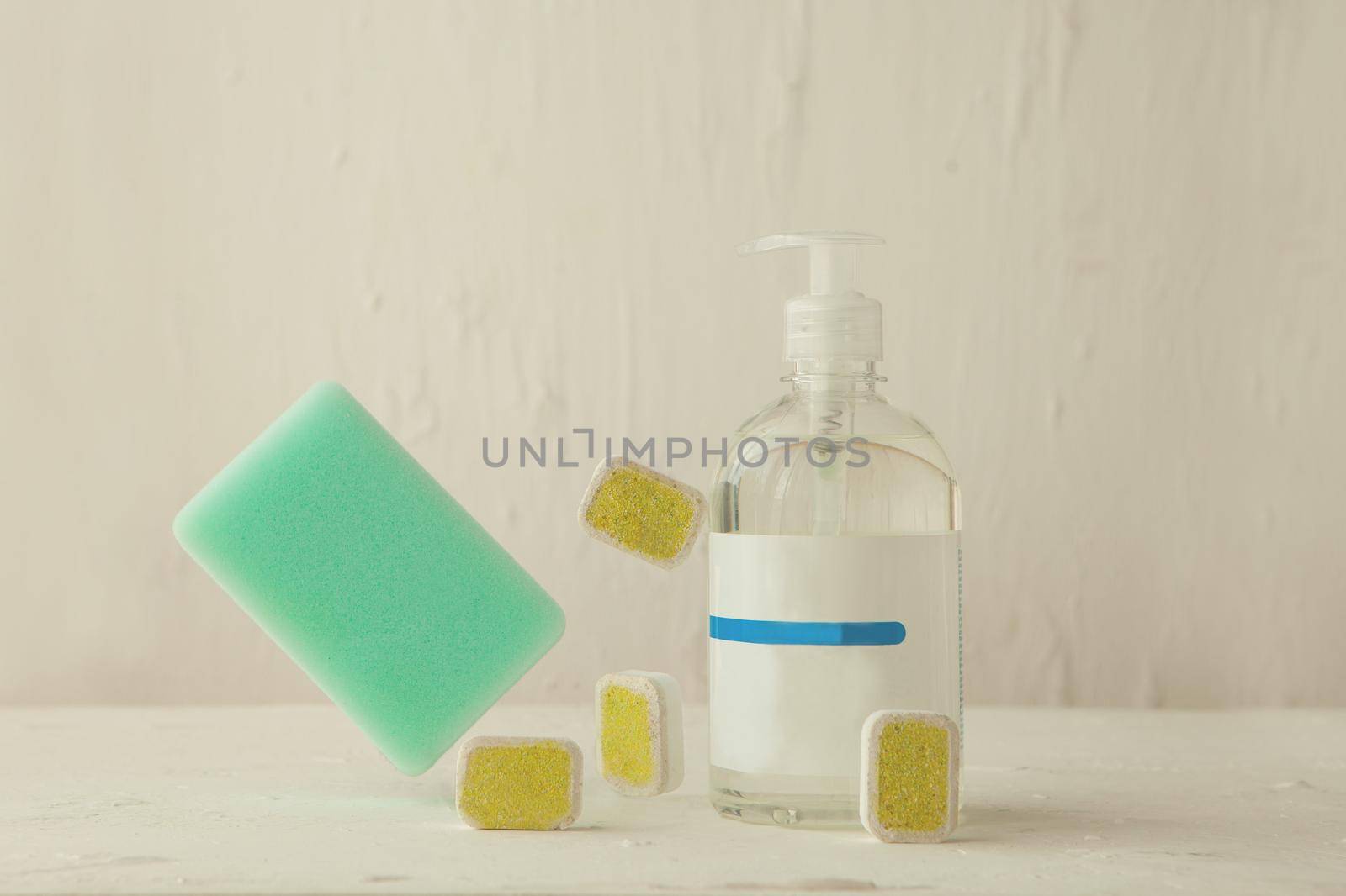 washing tablets and liquid in levitation. Dishwasher tabs for cleaning with cponge