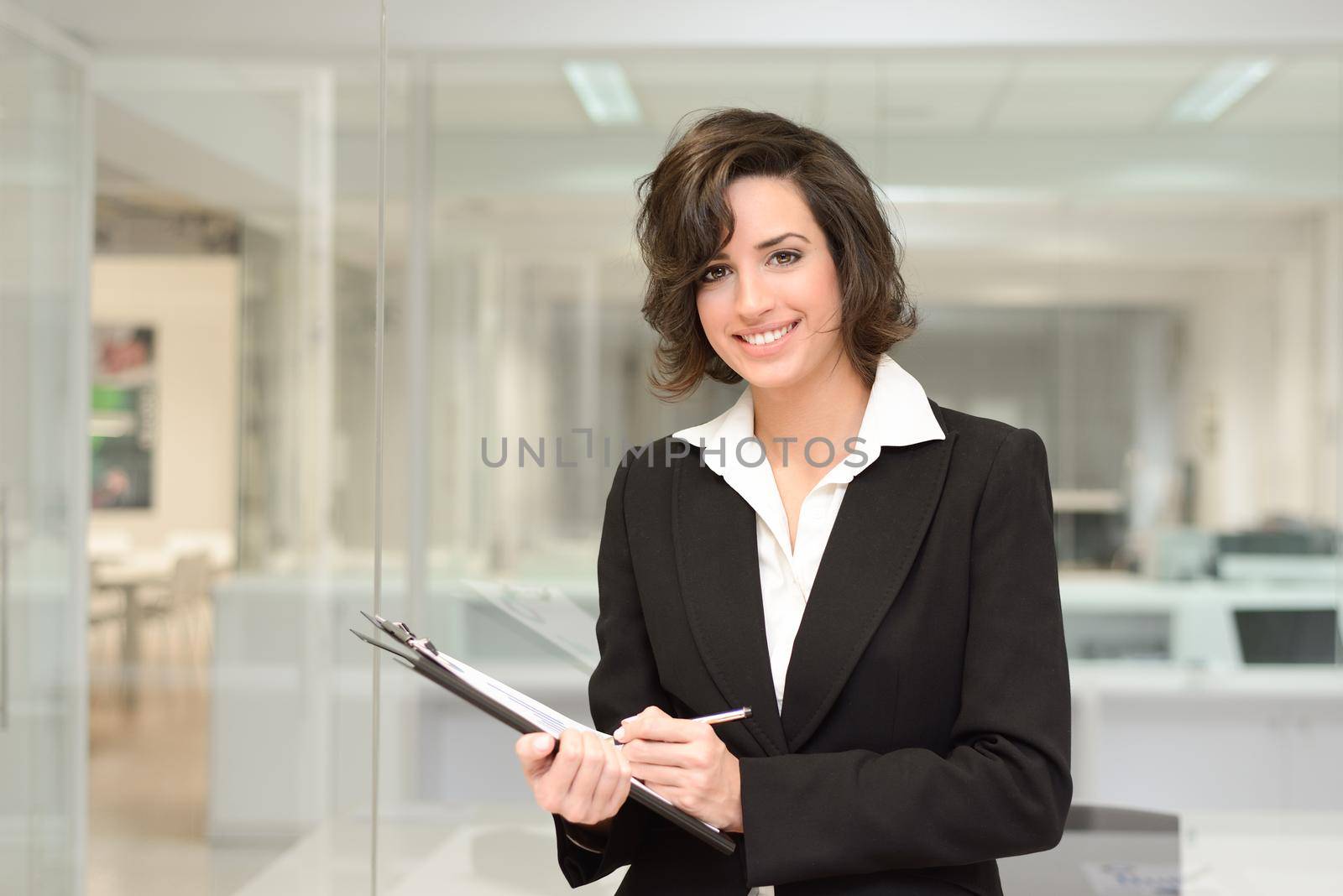 Businesswoman in modern office interior by javiindy