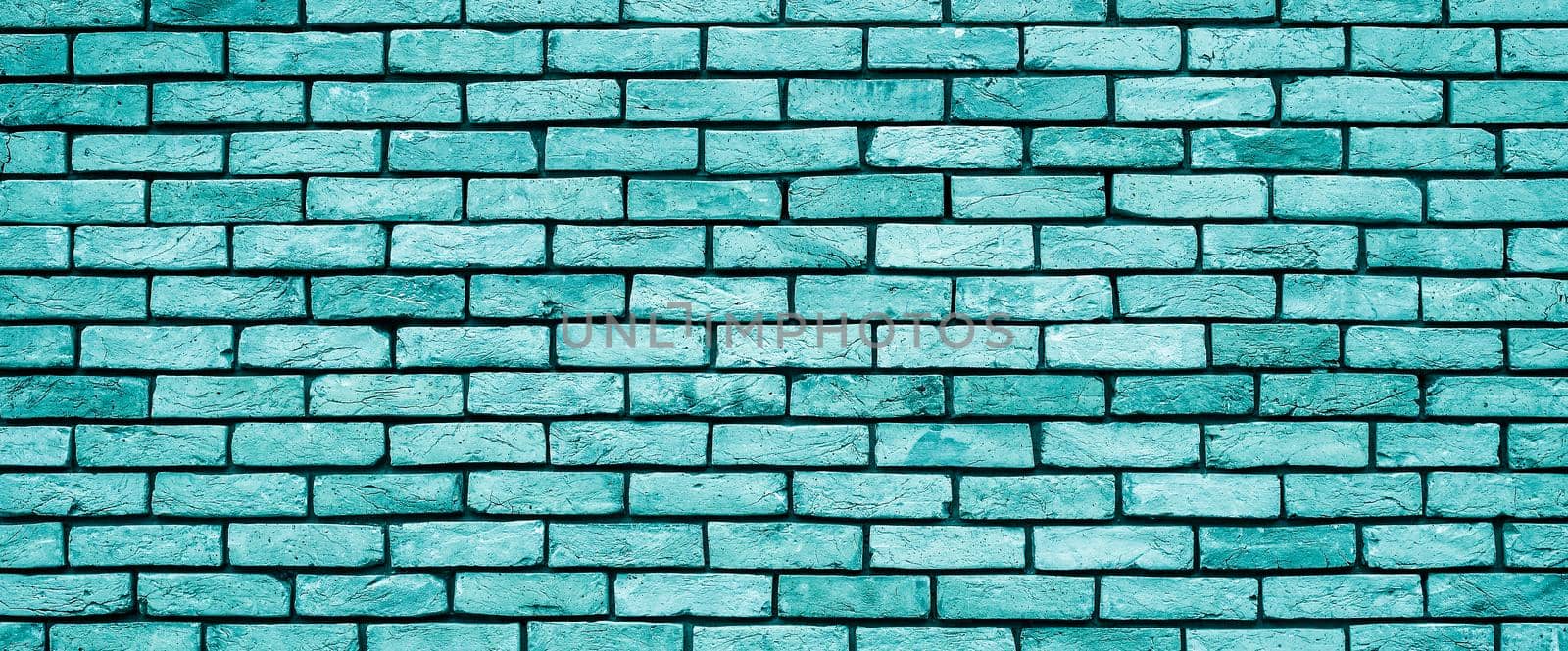 Bright blue Brick wall texture close up. Top view. Modern brick wall wallpaper design for web or graphic art projects. Abstract background for business cards and covers. Template or mock up.