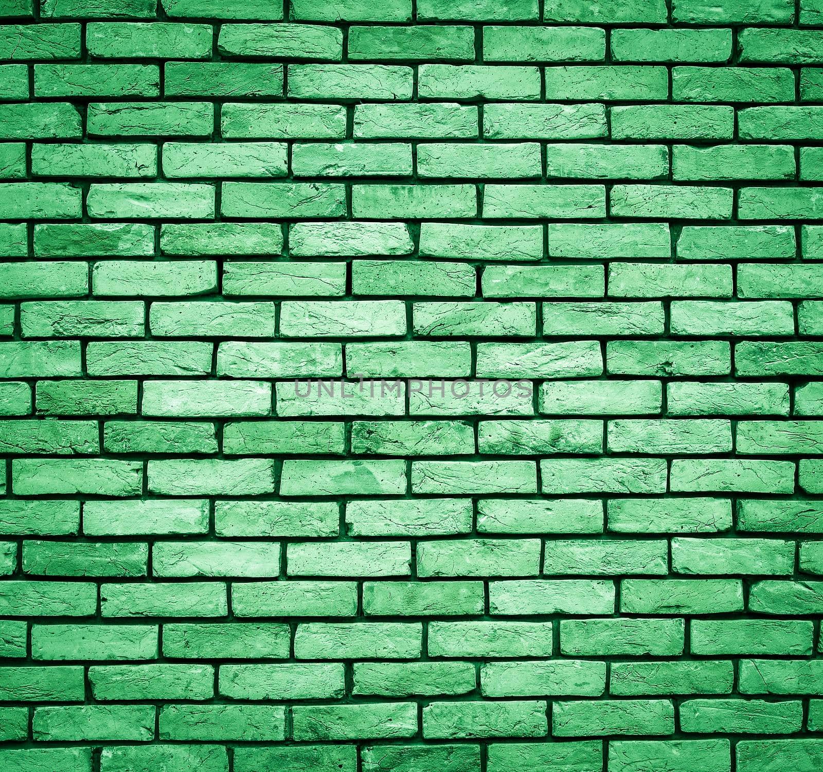 Green Brick wall texture close up. Top view. Modern brick wall wallpaper design for web or graphic art projects. Abstract background for business cards and covers. Template or mock up.