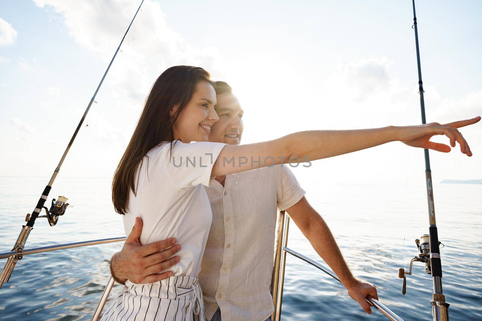 Happy couple in love on a yacht in summer on romantic vacation