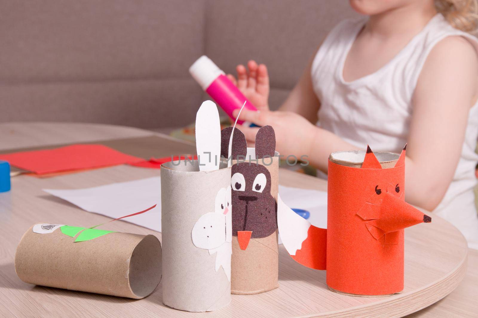 characters of fairy tales from toilet paper bushes and a small child in the background, colored paper crafts, what to do with the child at home, quarantine and self-isolation