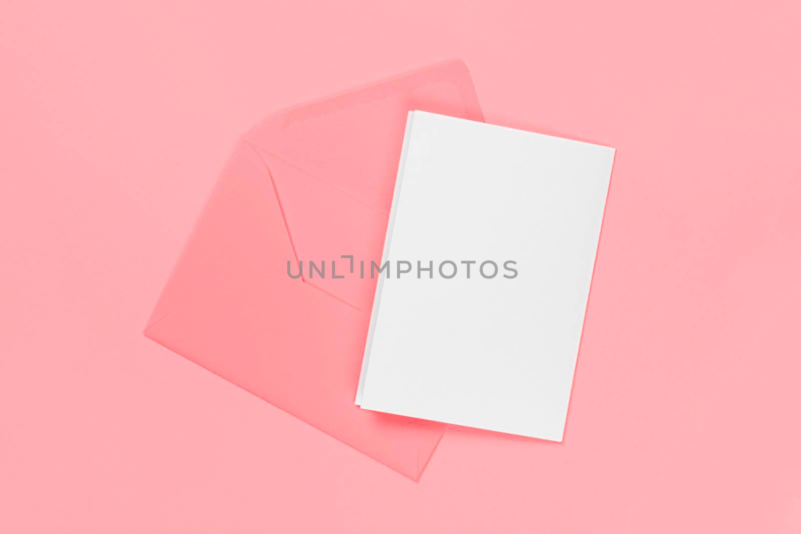Blank white card with pink envelope isolated on blue background. Template or mock up. Banner with copy space.