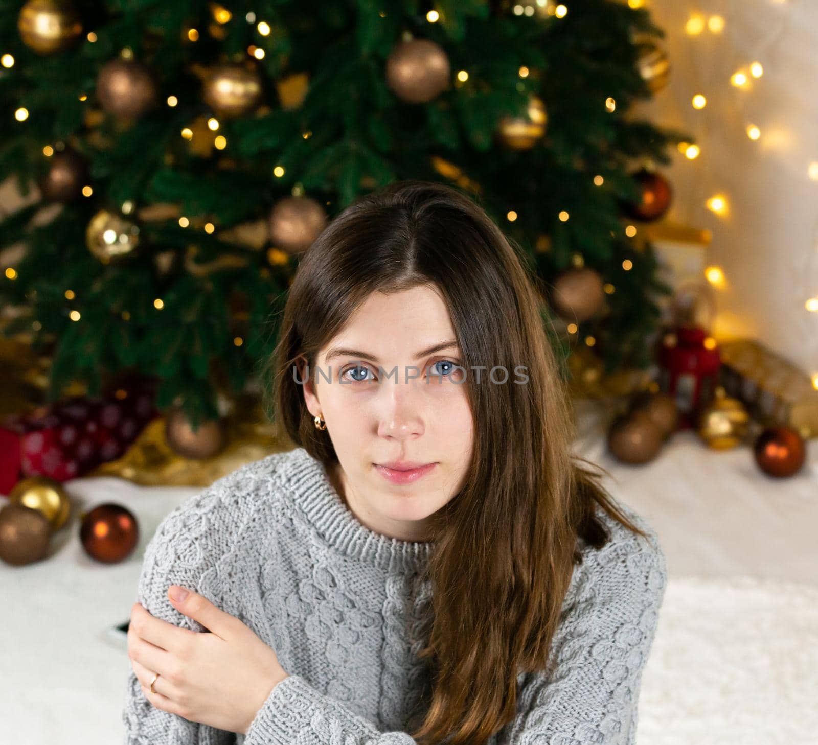 Fashion young beautiful woman in gray knitted dress near christmas tree. Fashion beautiful sensual new year woman