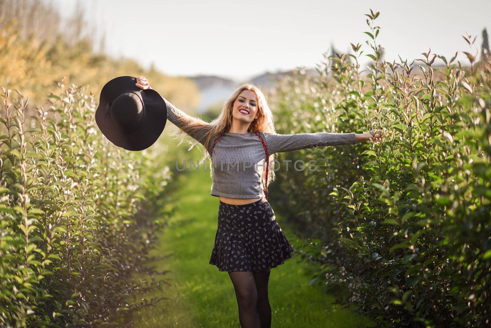 Blonde young woman happy in rural road by javiindy