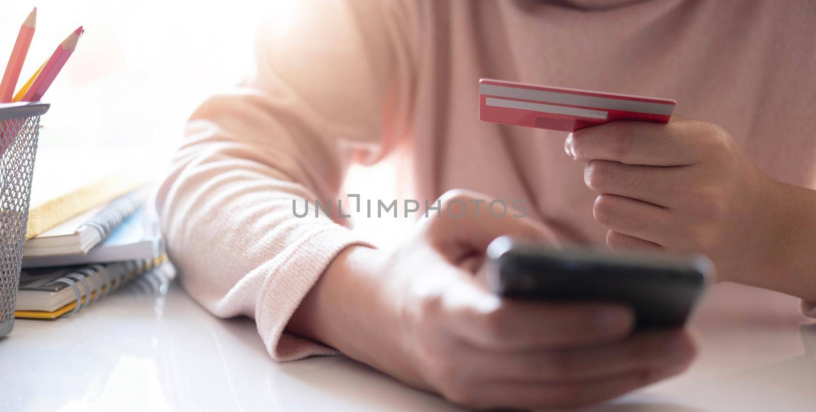 Online payment,Man's hands holding smartphone and using credit card for online shopping. Cyber Monday Concept by wichayada