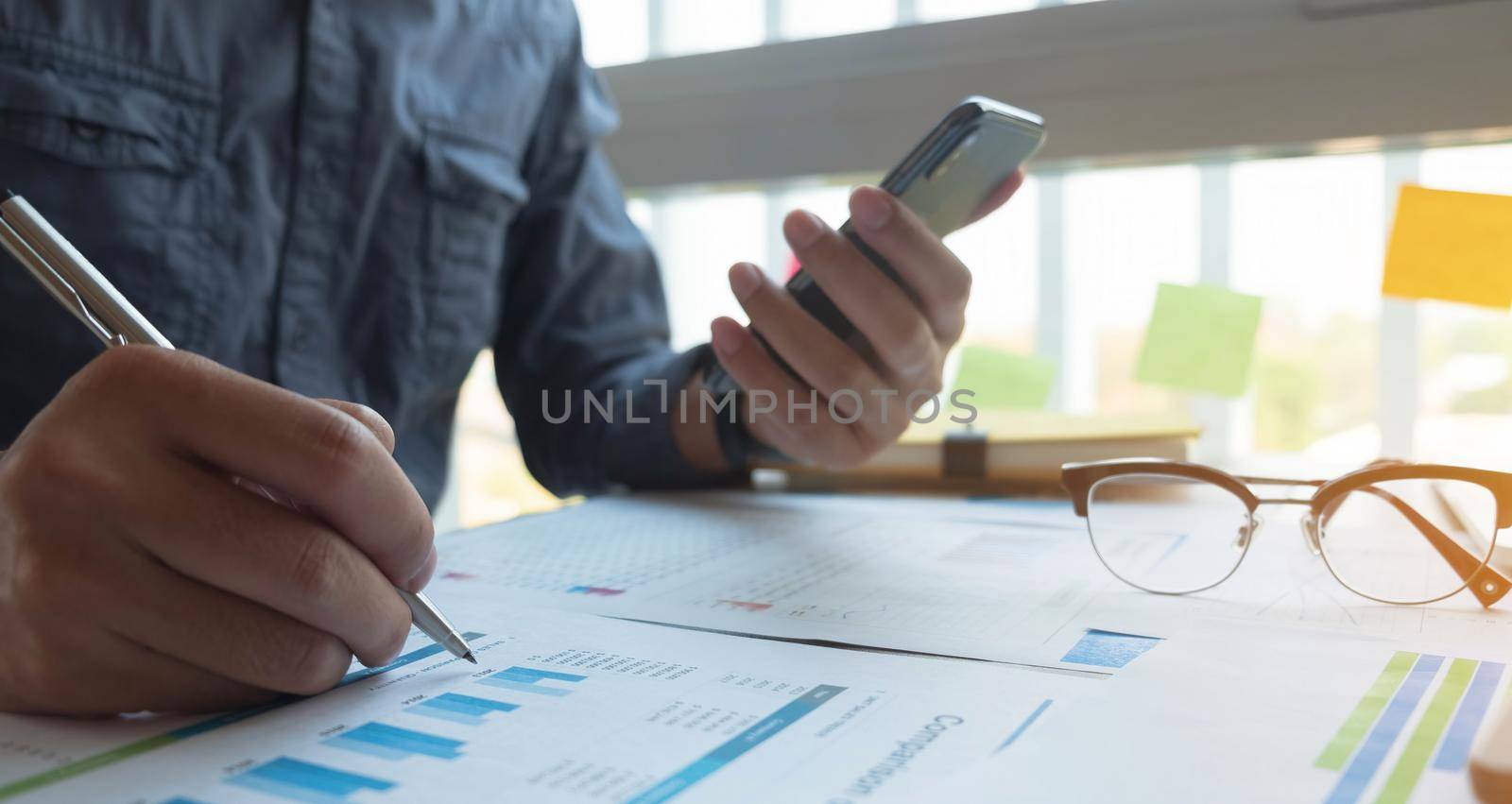 Close up focused financier reading paper contract agreement, checking latest investment news in smartphone application indoors, concentrated female editor reading document or report at workplace..
